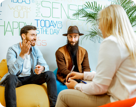 two adult guy talking to the female staff