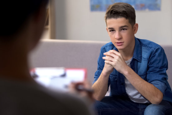 young boy talking to the staff